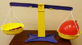 One empty and one inflated balloon on balance
